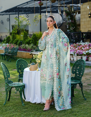 Woman in a light blue embroidered outfit. Lawn Embroidered Dress for Summer 2026