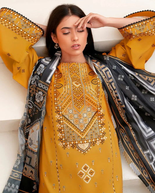 Woman wearing a yellow embroidered dress with a patterned dupatta