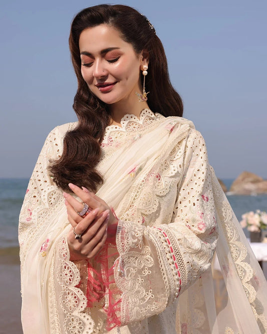 Woman in a traditional outfit with floral patterns by the sea